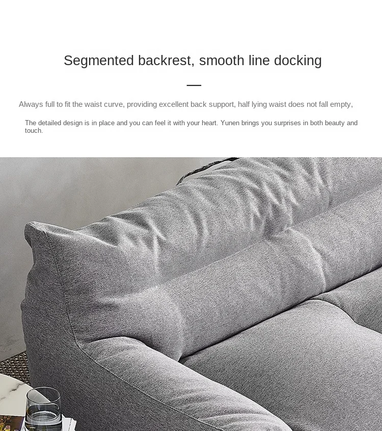 Un sofá gris con un acoplamiento de línea suave