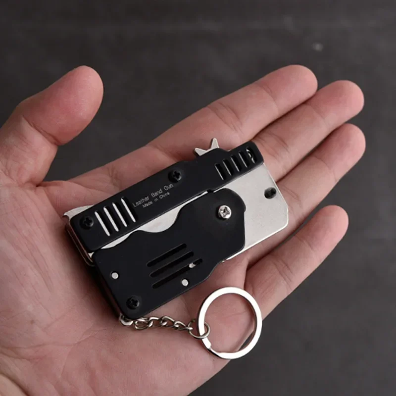 Mini llavero plegable para pistola de banda de goma, seis ráfagas, juguete de tiro de Metal, regalos, herramientas para exteriores, piezas de herramientas - imagen 3