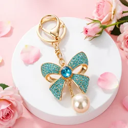 Llavero dorado con lazo, perlas y diamantes de imitación para bolso