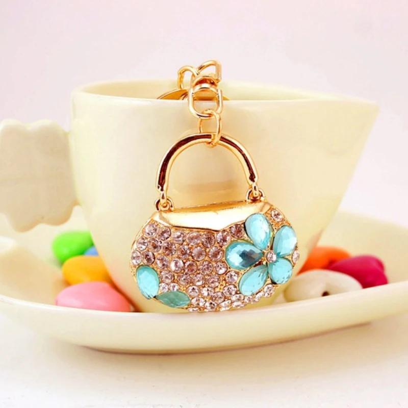 Llavero bolso flor cristal azul metal dorado strass
