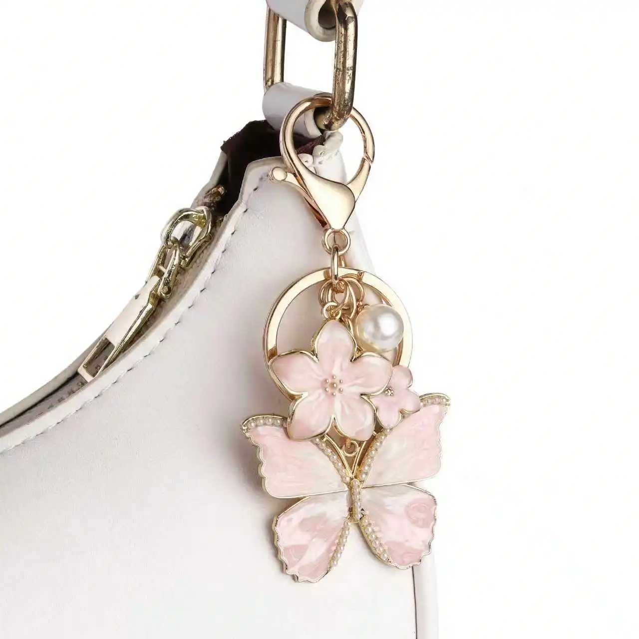 Portachiavi con perla en forma de mariposa y flor metálico