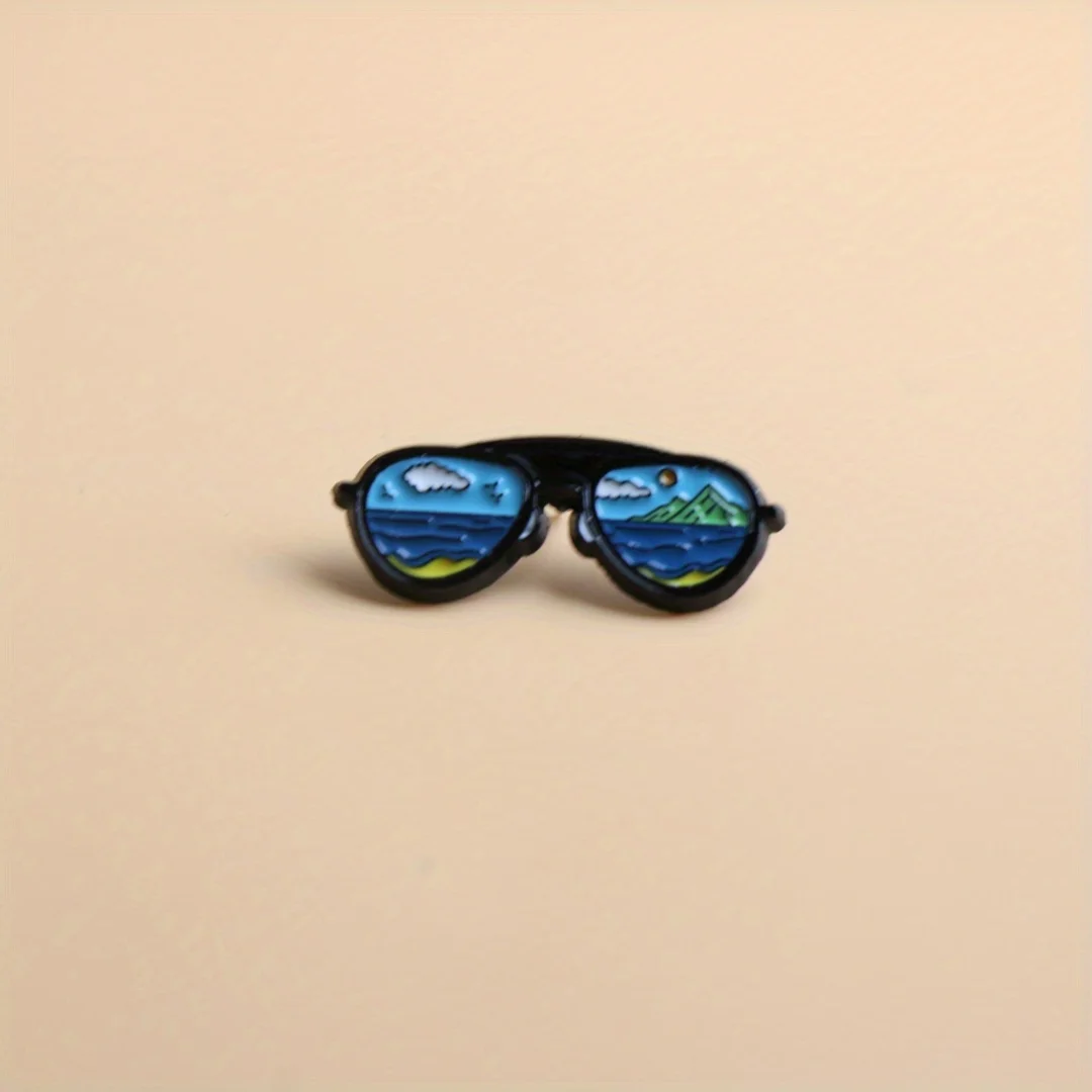 Broche metálico con diseño de gafas
