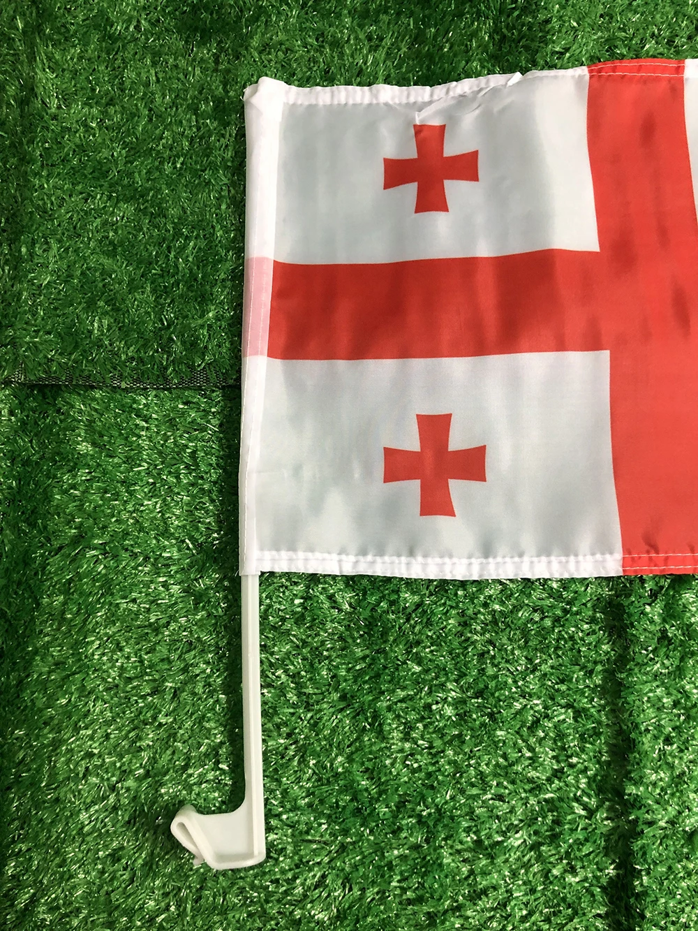 Bandera de Georgia sobre superficie plana